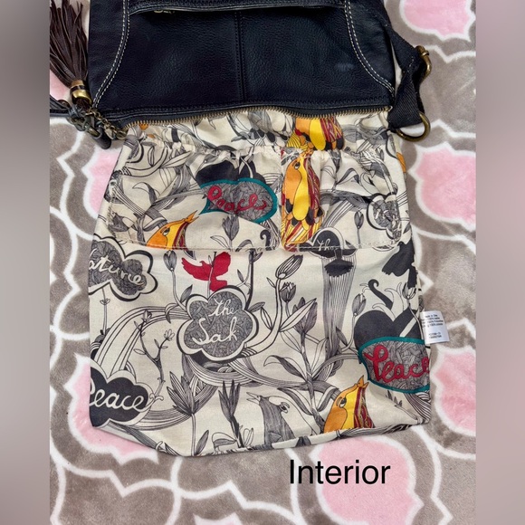 The Sak Black Genuine Leather Tassel Crossbody with Peace Print Interior - Picture 6 of 9